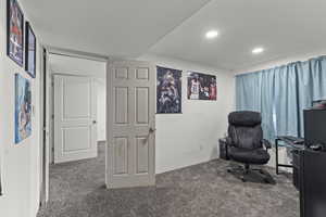 Carpeted home office with recessed lighting