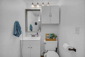 Bathroom featuring vanity and a textured wall