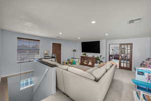 Living room featuring light colored carpet and recessed lighting