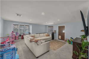 Living room featuring carpet floors and recessed lighting