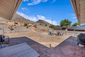 Fenced backyard with a patio area and an outdoor fire pit
