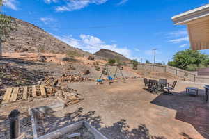 Fenced backyard with a patio and outdoor dining area