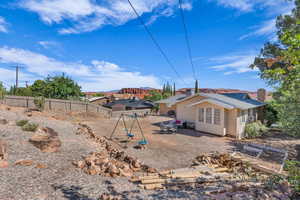 Rear view of property featuring a patio area, a fenced backyard, and a chimney