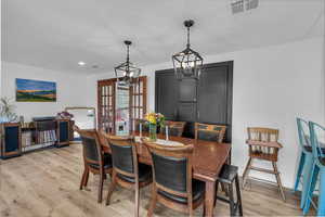 Dining area featuring light wood-style flooring, french doors, and recessed lighting