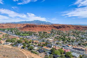 Aerial perspective of suburban area featuring a mountainous background