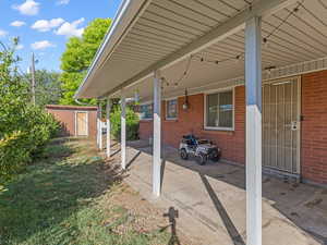 View of patio / terrace featuring a storage shed