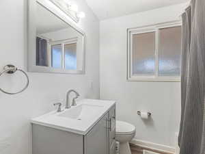 Full bath with vanity, shower / bath combo