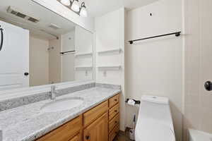 Bathroom with vanity and a textured ceiling