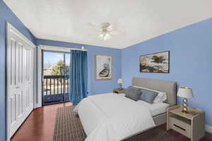 Bedroom with access to outside, wood finished floors, a closet, a ceiling fan, and a textured ceiling