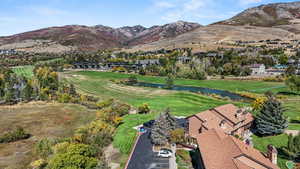View of property location featuring a water and mountain view and a golf club