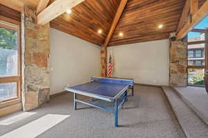 Rec room with healthy amount of natural light, carpet flooring, a wooden ceiling with exposed beams, high vaulted ceiling, and recessed lighting