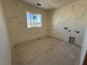 Unfurnished room featuring a textured ceiling