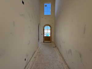 Hallway with a towering ceiling and arched walkways