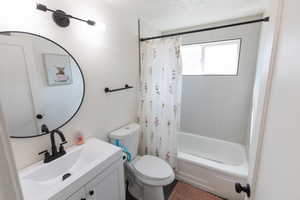 Bathroom with vanity and shower / tub combo