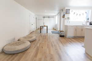 Dining room with a barn door and light wood finished floors