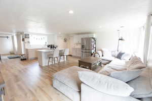 Living room featuring light wood-style floors and recessed lighting