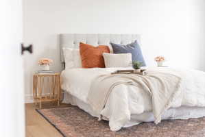 Bedroom with wood finished floors and baseboards