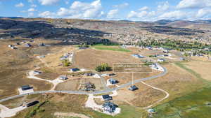 Aerial view of property and surrounding area with a mountainous background and rural landscape