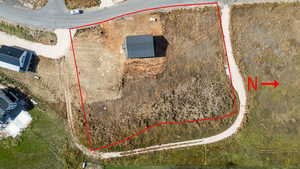 Aerial view of property and surrounding area featuring property parcel outlined