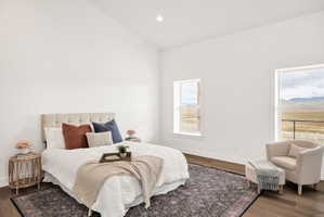 Bedroom featuring wood finished floors, vaulted ceiling, and recessed lighting