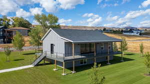 Rear view of house with covered walk-around deck. Landscape is virtual