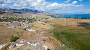 Aerial view of property's location featuring a water and mountain view