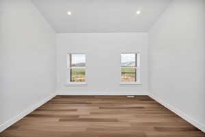 Unfurnished room featuring healthy amount of natural light, light wood finished floors, and recessed lighting