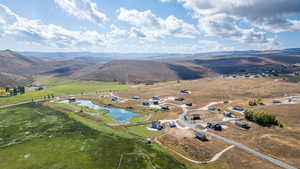 Aerial view of property's location with rural landscape and a water and mountain view