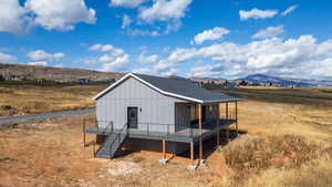 View of outdoor structure featuring a mountain view, stairway, and a view of rural / pastoral area