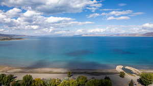 Water view featuring a mountain backdrop and nearby beach