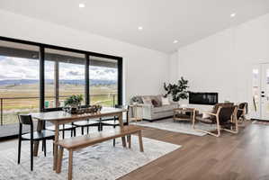 Dining room with lofted ceiling, a mountain view, wood finished floors, french doors, and recessed lighting