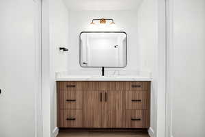 Bathroom featuring vanity and dark wood-type flooring