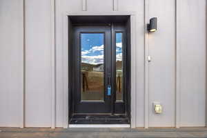 Property entrance featuring board and batten siding
