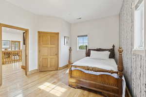 Bedroom featuring light wood-style floors and baseboards