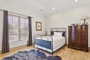 Bedroom with light wood-style floors and recessed lighting