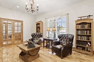 Living area featuring hardwood / wood-style floors, a chandelier, french doors, and recessed lighting