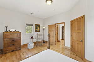 Bedroom featuring light wood finished floors and baseboards