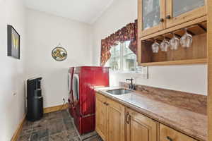 Washroom with stone finish flooring, and cabinet space
