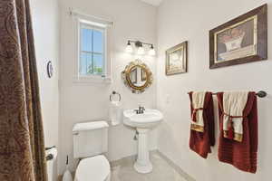Bathroom featuring baseboards and tile patterned floors