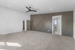 Unfurnished bedroom featuring light colored carpet, ceiling fan, recessed lighting, and connected bathroom