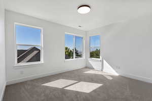 Empty room with carpet flooring and baseboards