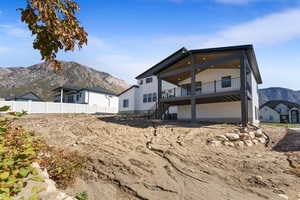 Rear view of house with a mountain view and stairway