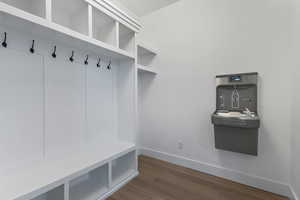 Mudroom with dark wood-type flooring and baseboards