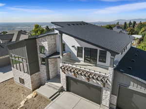 Rear view of property with stone siding and a mountain view