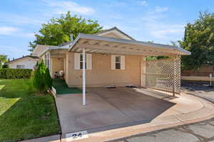 View of front facade with stucco siding and a front yard
