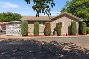 View of front of property featuring stucco siding and a tile roof