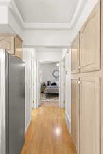 Corridor with light wood-style floors and baseboards
