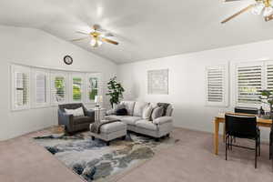 Living room with ceiling fan, carpet, lofted ceiling, and an office area
