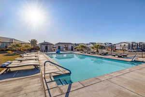 Community pool featuring a residential view and a patio