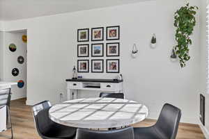 Dining space with light wood-style floors and baseboards